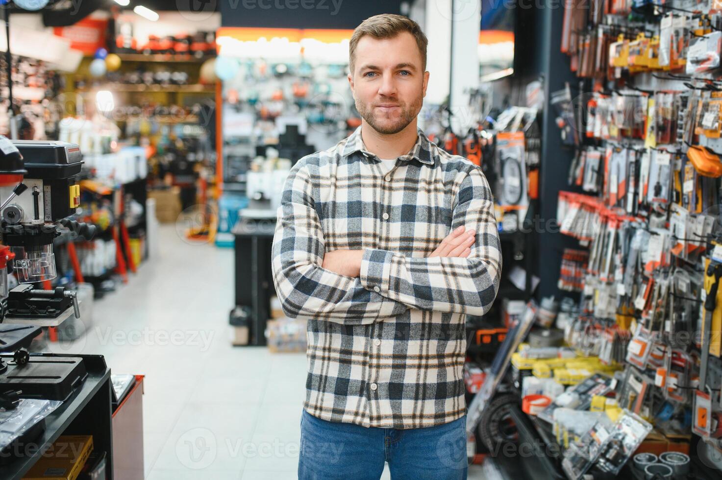 A man in a hardware store choosing a tool photo