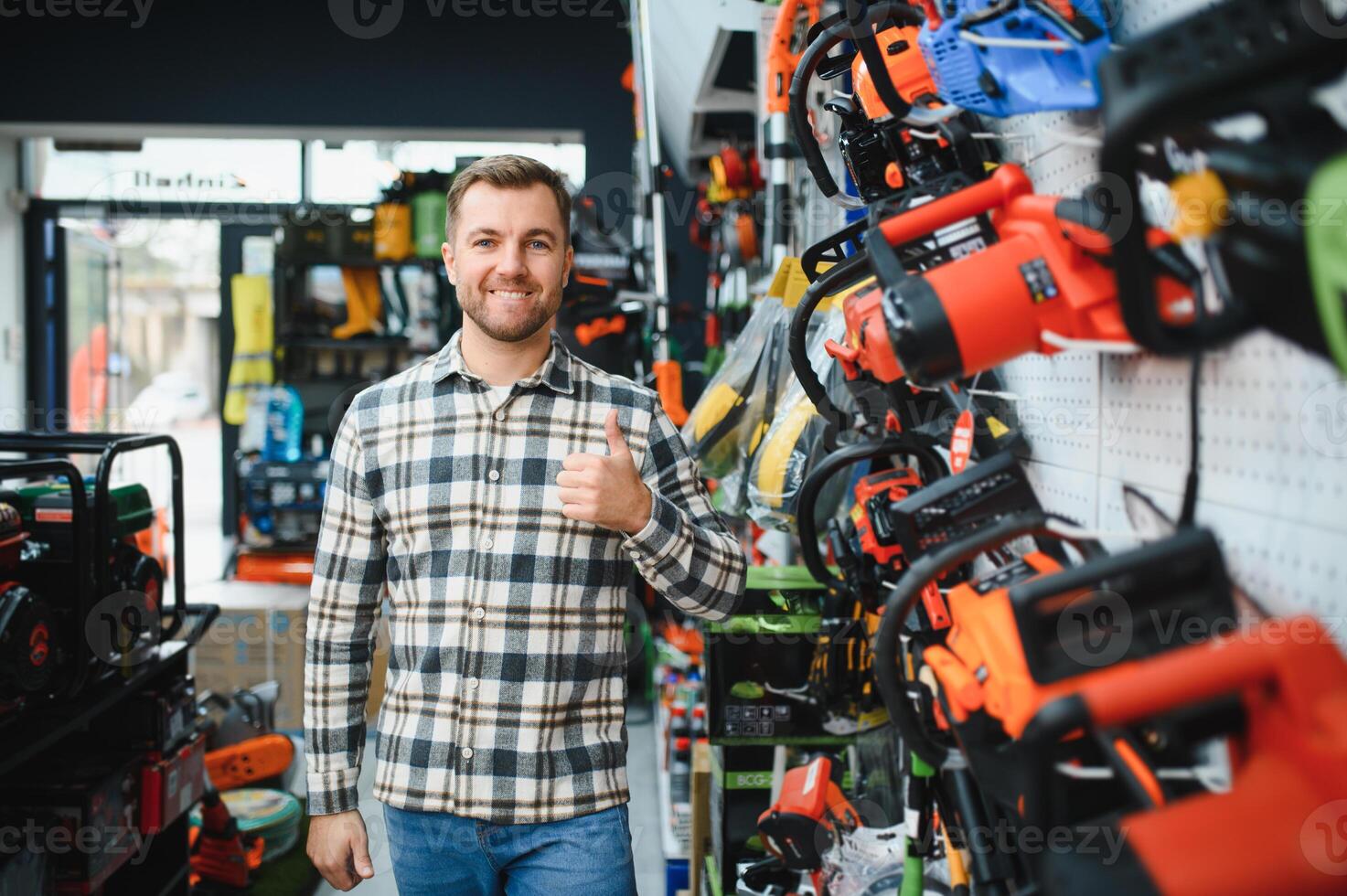 A man in a hardware store choosing a tool photo