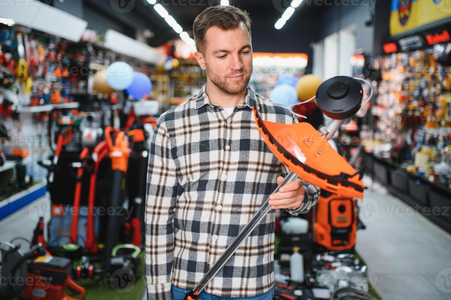 A man in a hardware store choosing a tool photo
