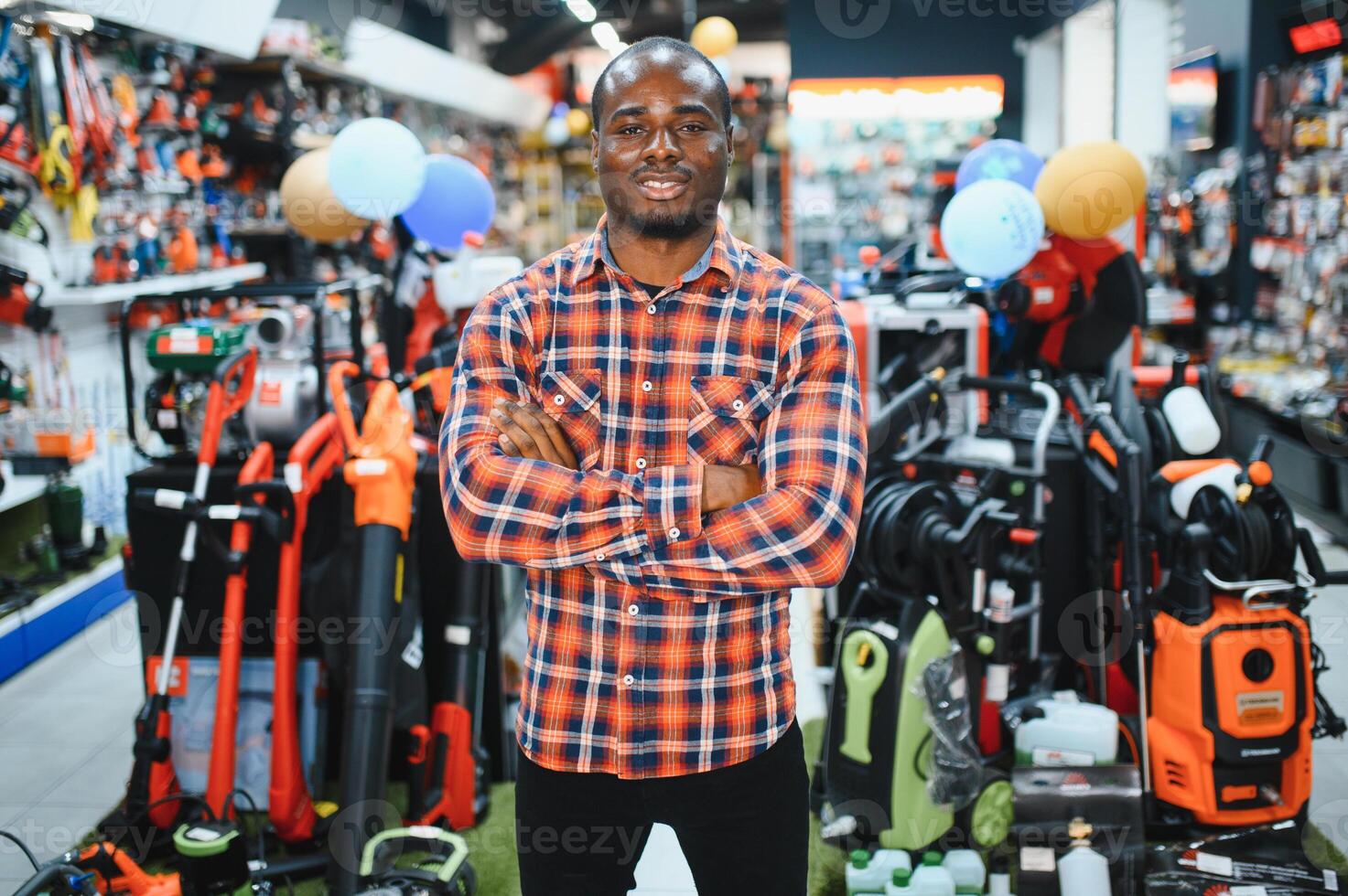 A african american man chooses a power tool in a hardware store photo