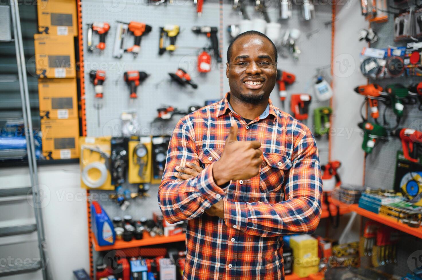 A african american man chooses a power tool in a hardware store photo