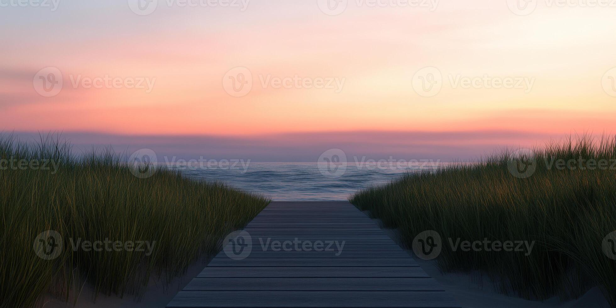 Pathway through grass leads to serene beach at sunset photo