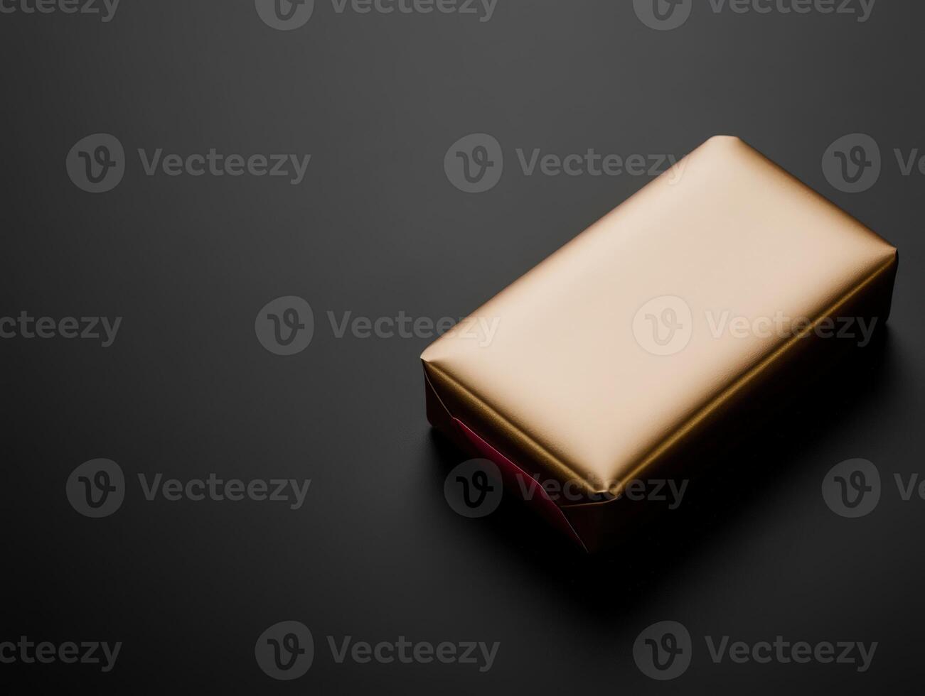 Elegant gold wrapped package on a dark surface photo