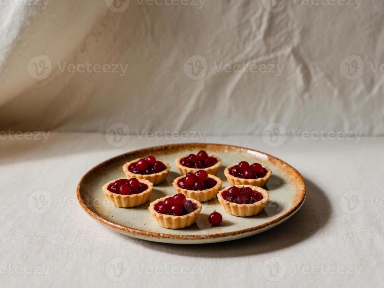 Redcurrant tartlets on a plate on light rustic background. photo