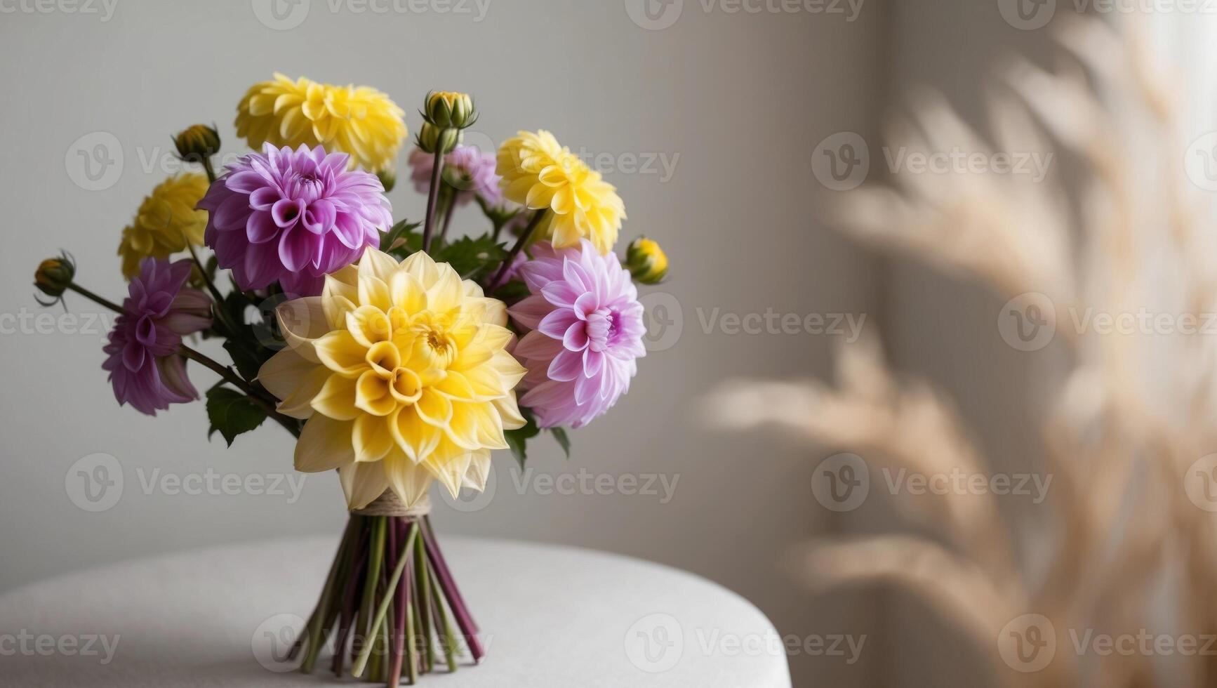 A bouquet of flowers with yellow and purple dahlias. photo