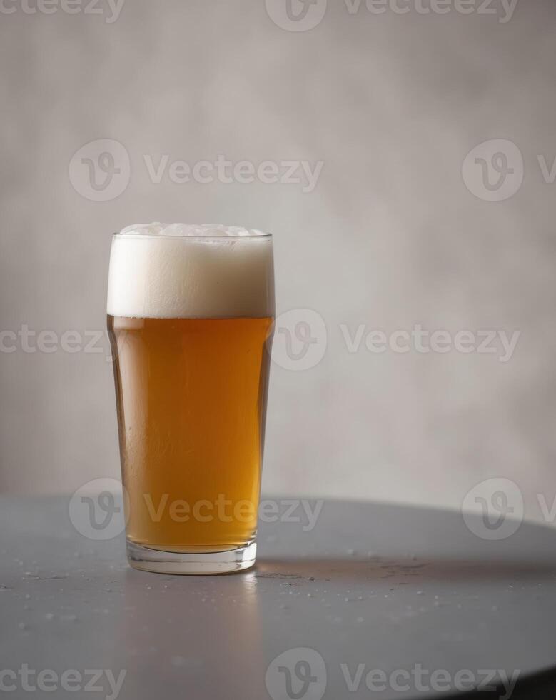 Glass of beer on table or Beverage in glass with foamy head or Beer in photo