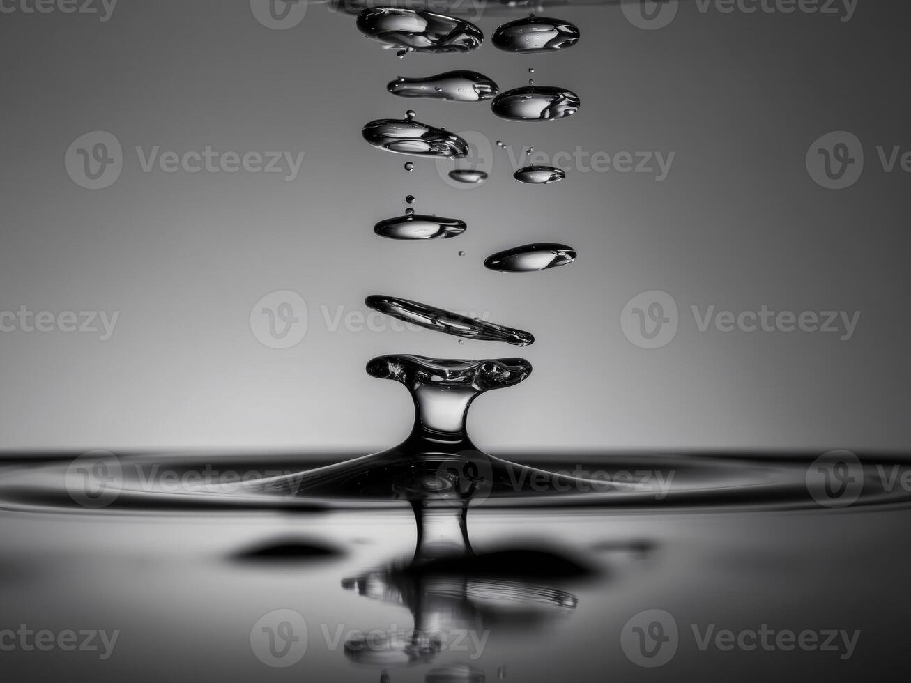Macro view of water droplets falling onto a smooth surface. photo