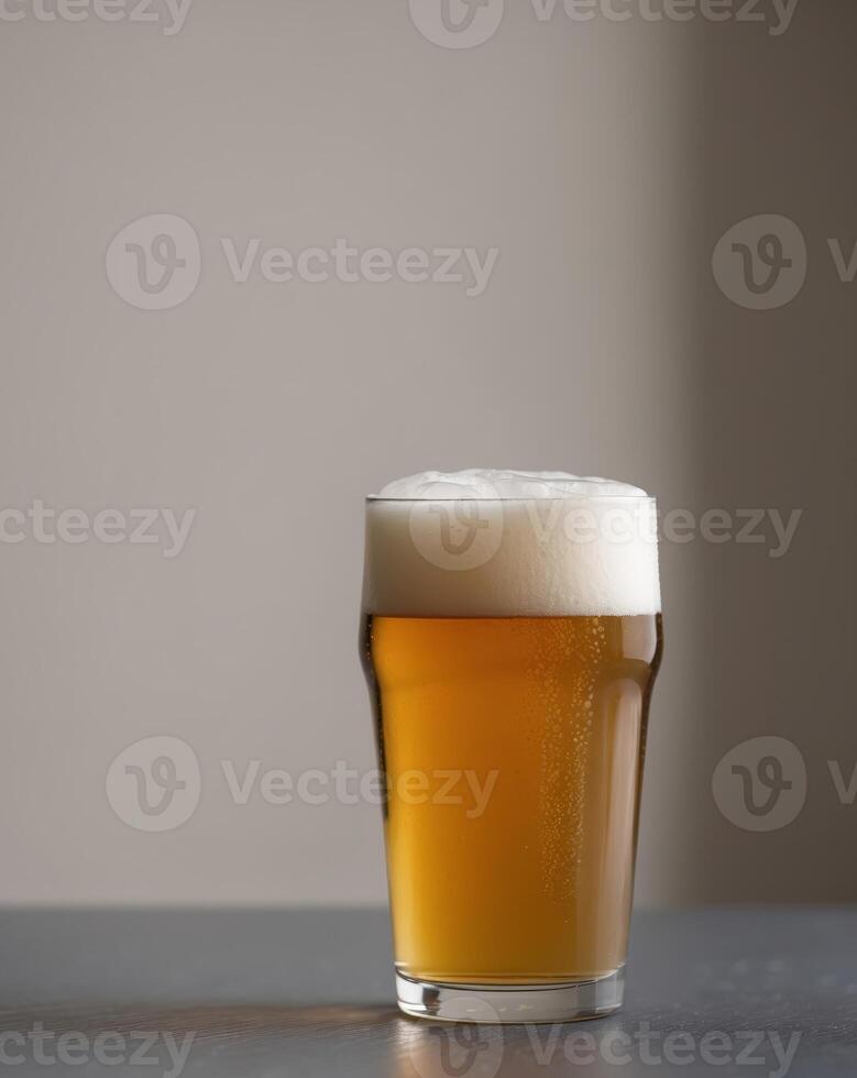 Glass of beer on table or Beverage in glass with foamy head or Beer in photo