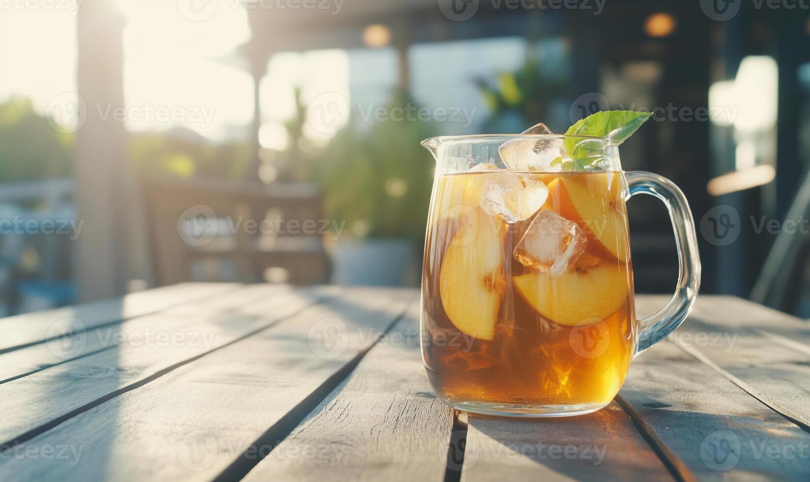 A refreshing pitcher of iced tea with apple slices and mint. photo