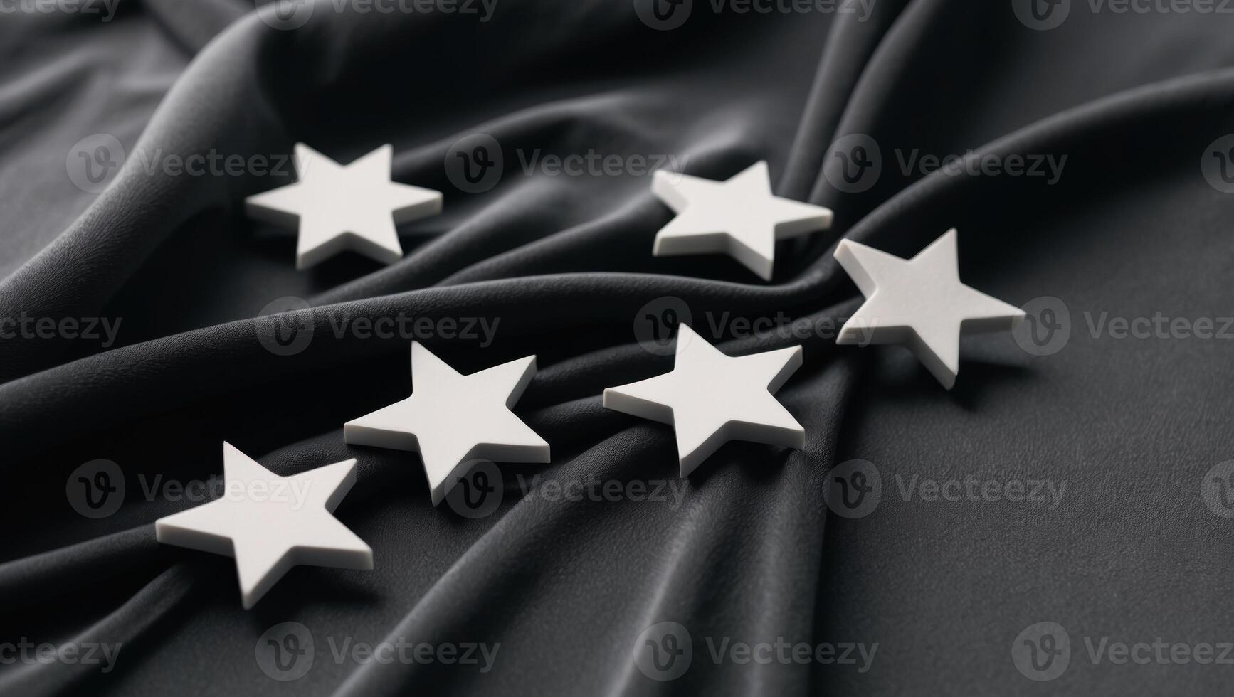 A group of six stars are on a black cloth. photo