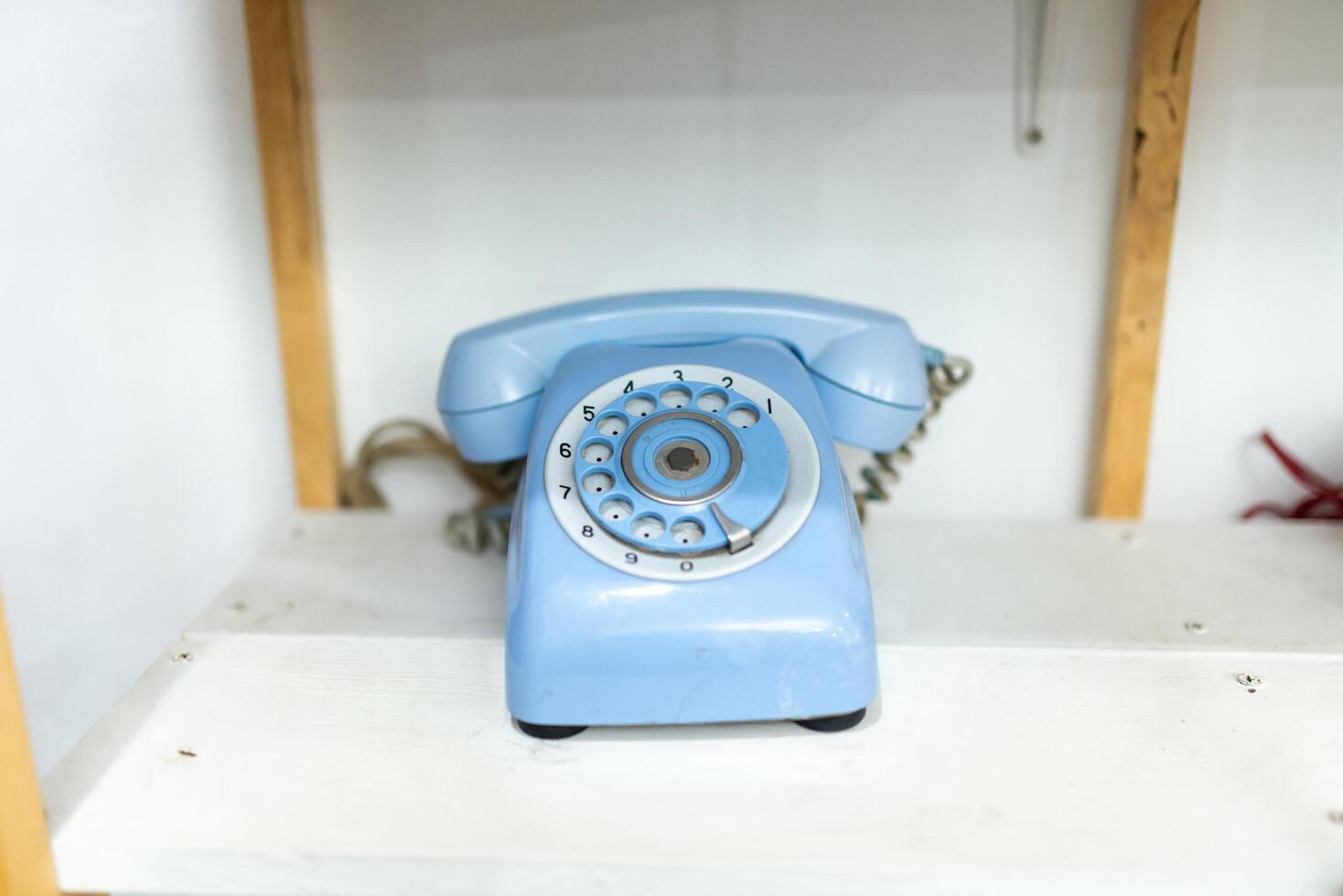 Old telephone on white background. Shallow depth of field. photo