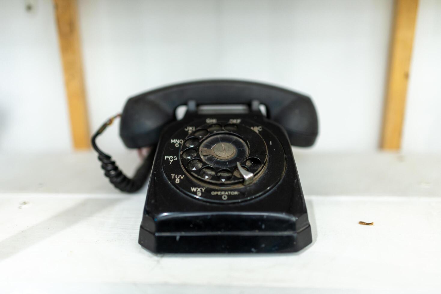 Old telephone on white background. Shallow depth of field. photo