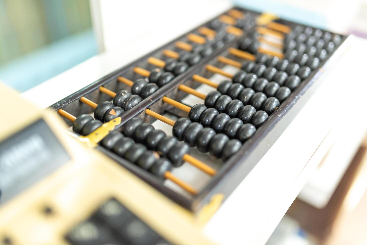 abacus and calculator on the table in the office, business concept photo