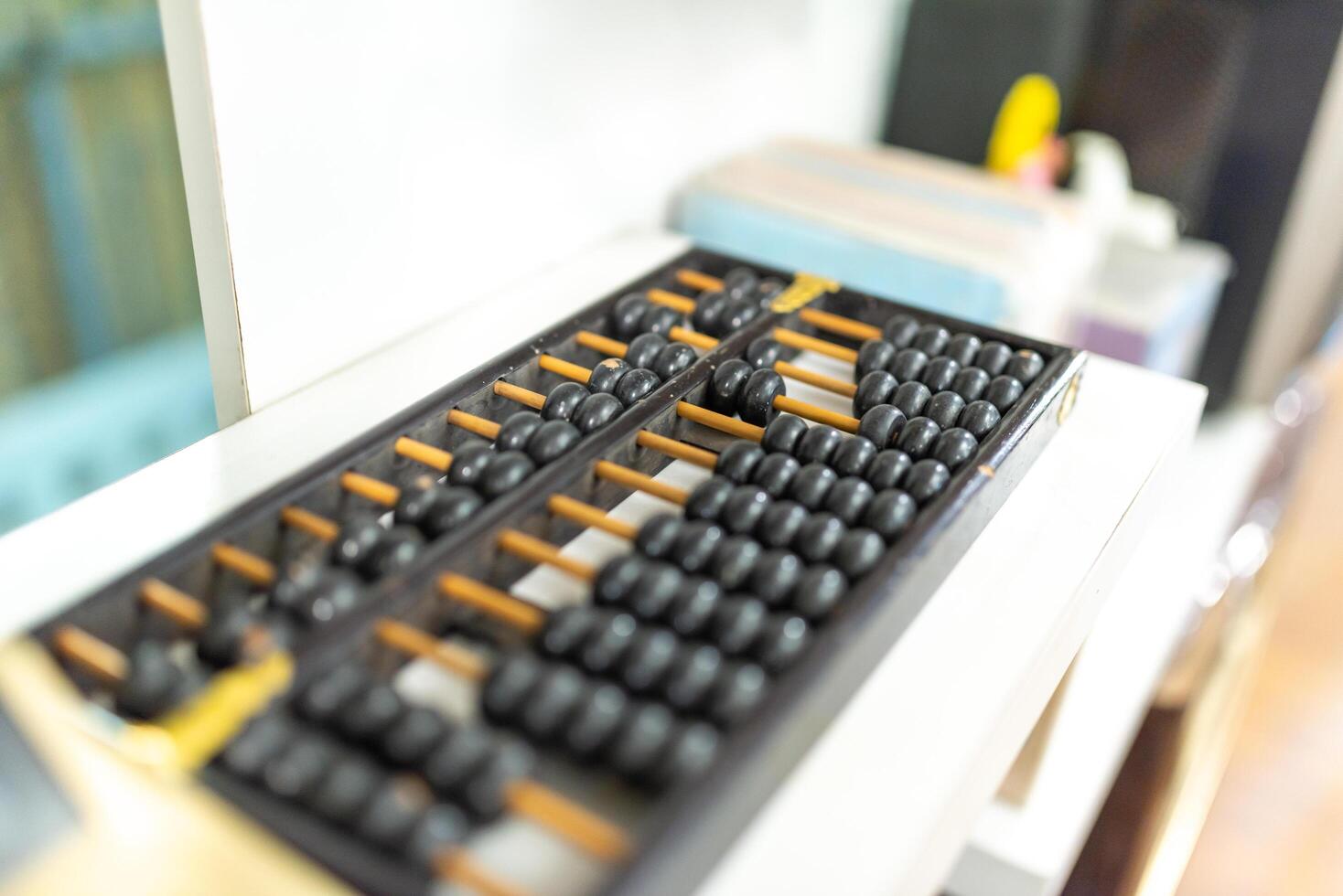 abacus and calculator on the table in the office, business concept photo