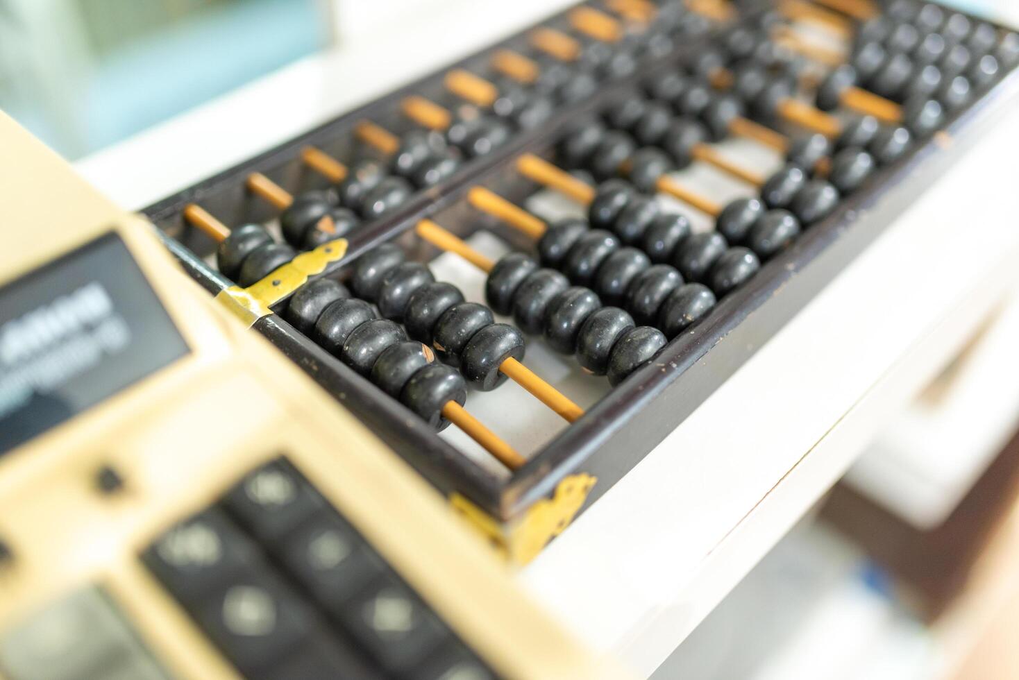 abacus and calculator on the table in the office, business concept photo