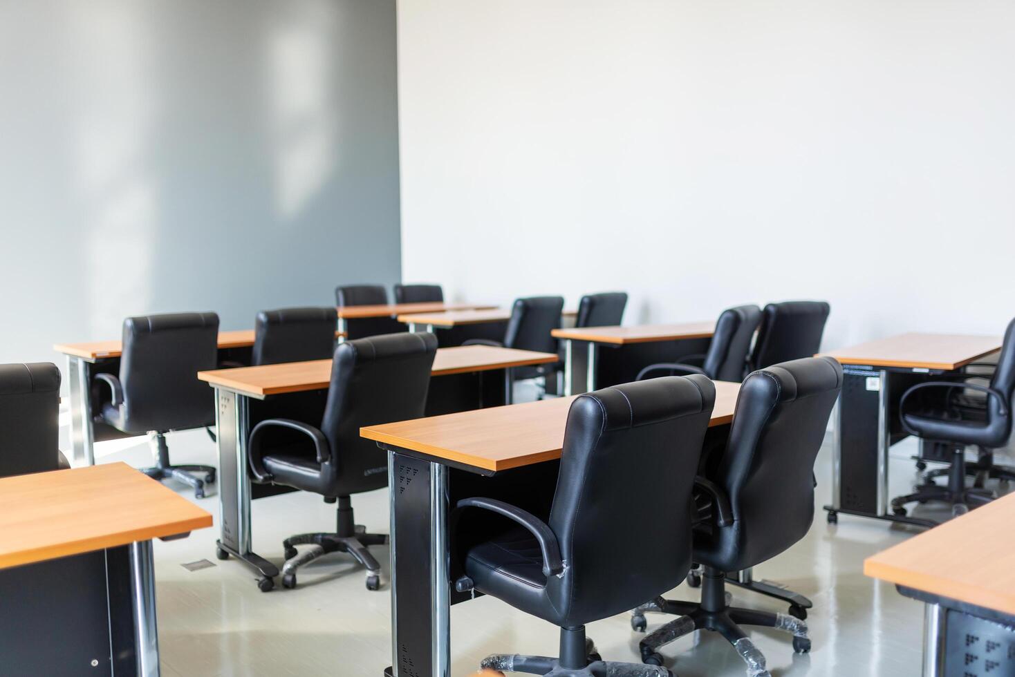 Empty classroom with table and chairs for lecture or seminar in university. photo