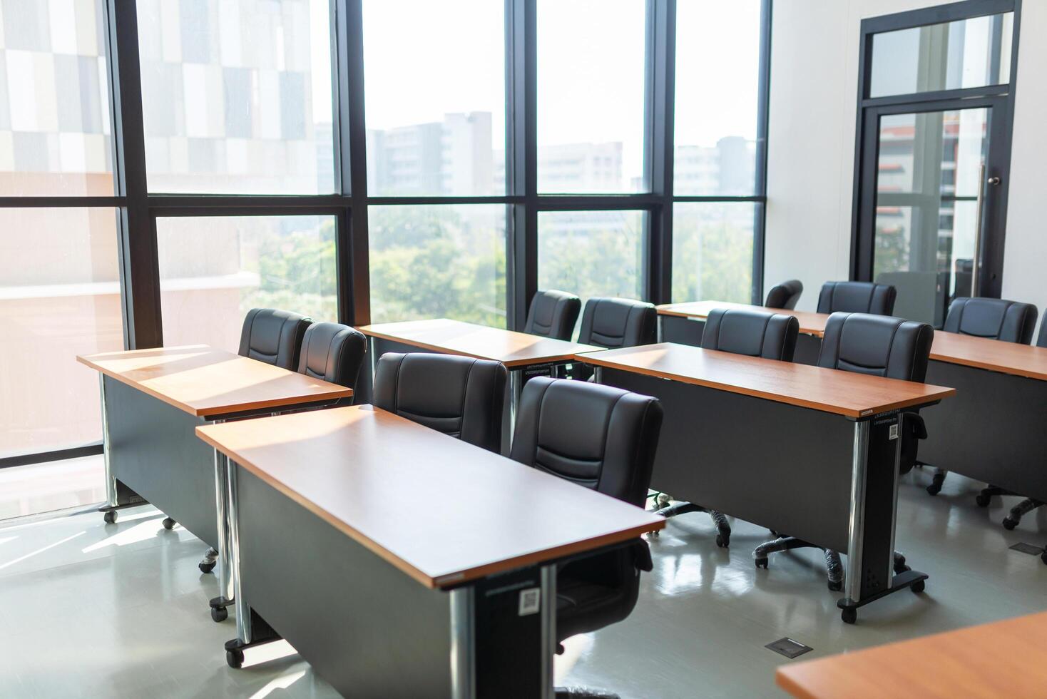 Empty classroom with table and chairs for lecture or seminar in university. photo