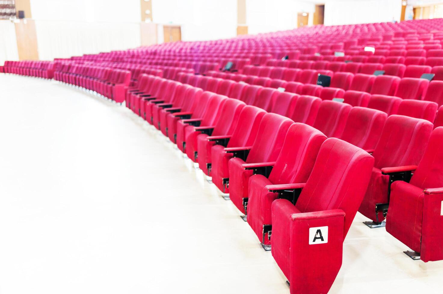 Empty seat on row in thearter closeup photo