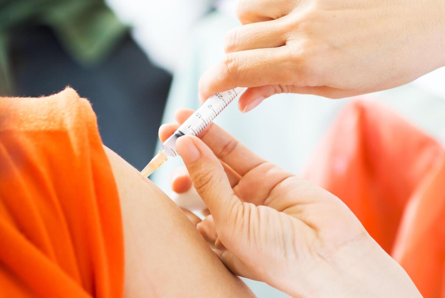 The doctor gave vaccination needle photo