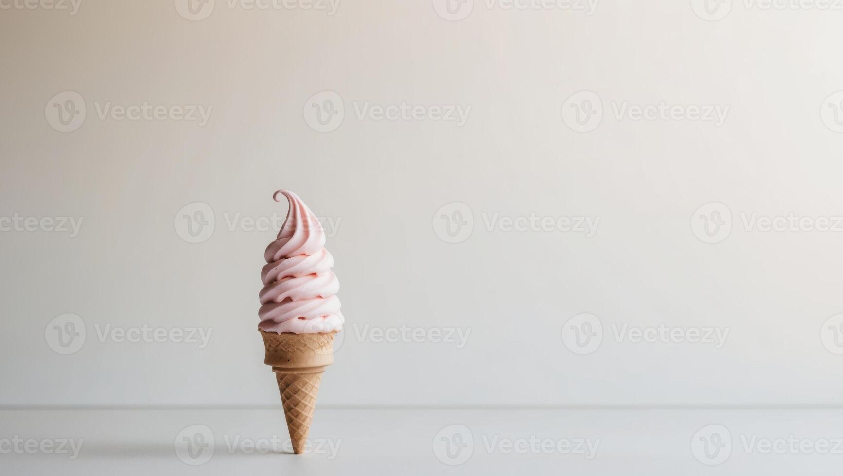 Soft serve ice cream cone with a swirl of pink. photo