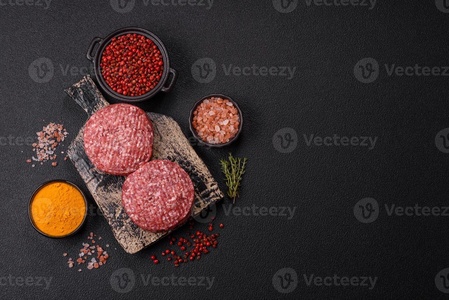 Fresh raw ground beef burger patty with salt and spices photo