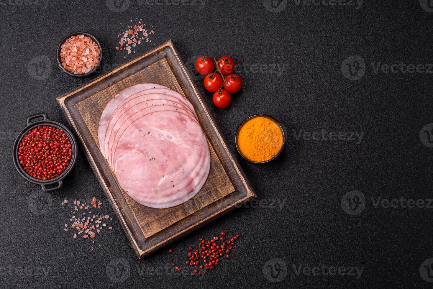 Smoked ham with salt, spices and herbs cut into round slices photo