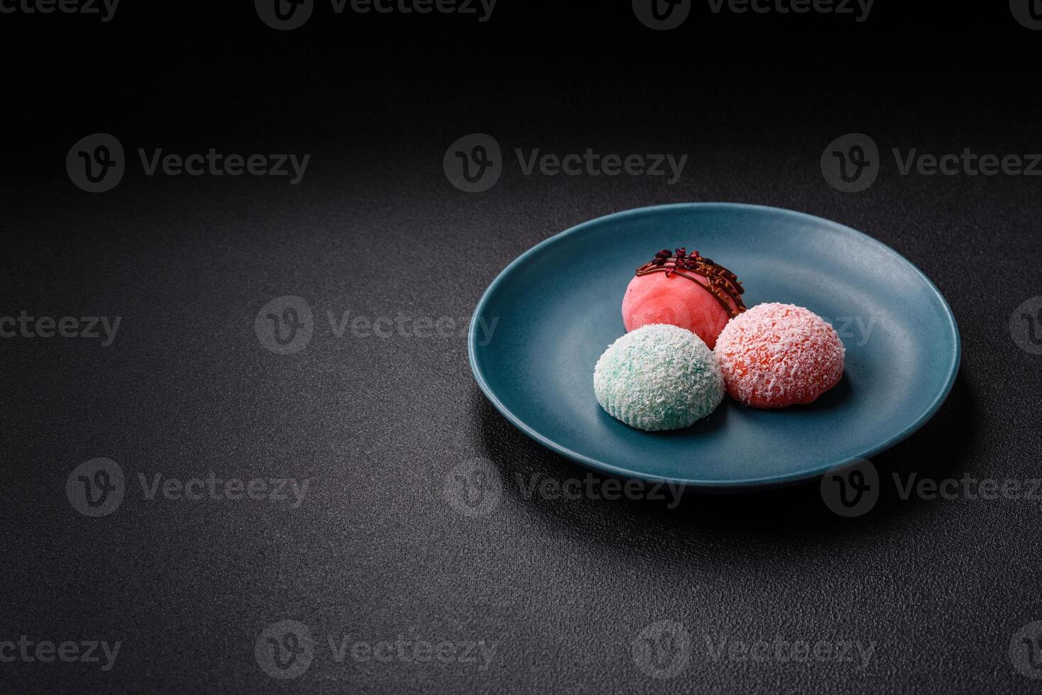 Delicious colorful asian mochi sweets with rice dough shell and fruit filling photo