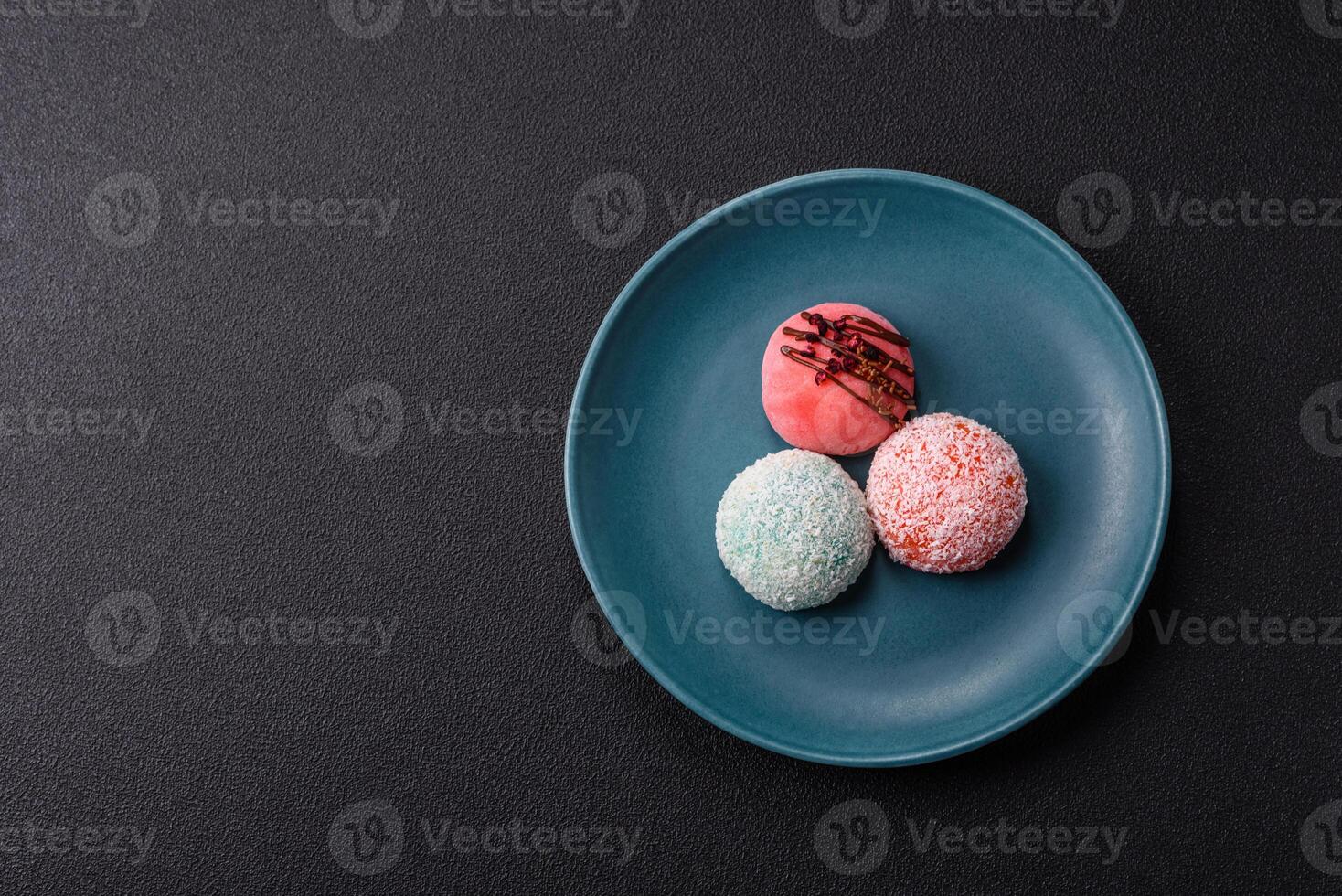 Delicious colorful asian mochi sweets with rice dough shell and fruit filling photo