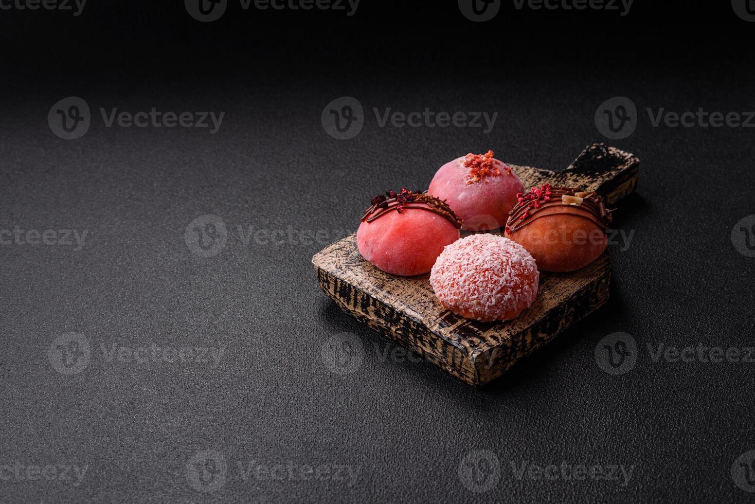 Delicious colorful asian mochi sweets with rice dough shell and fruit filling photo