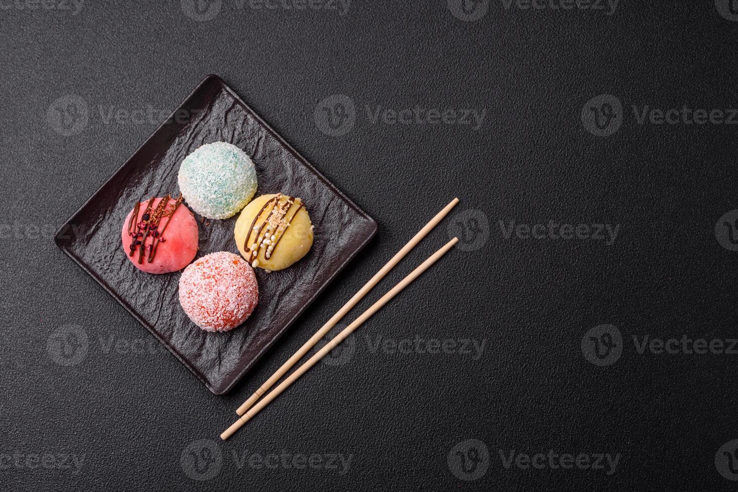Delicious colorful asian mochi sweets with rice dough shell and fruit filling photo