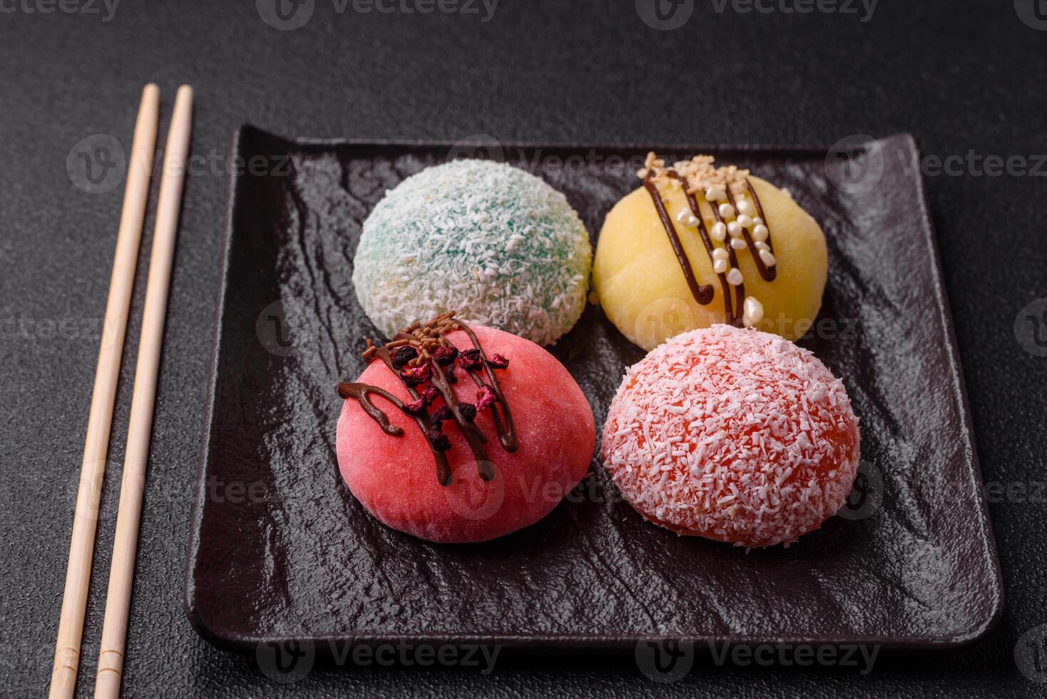 Delicious colorful asian mochi sweets with rice dough shell and fruit filling photo