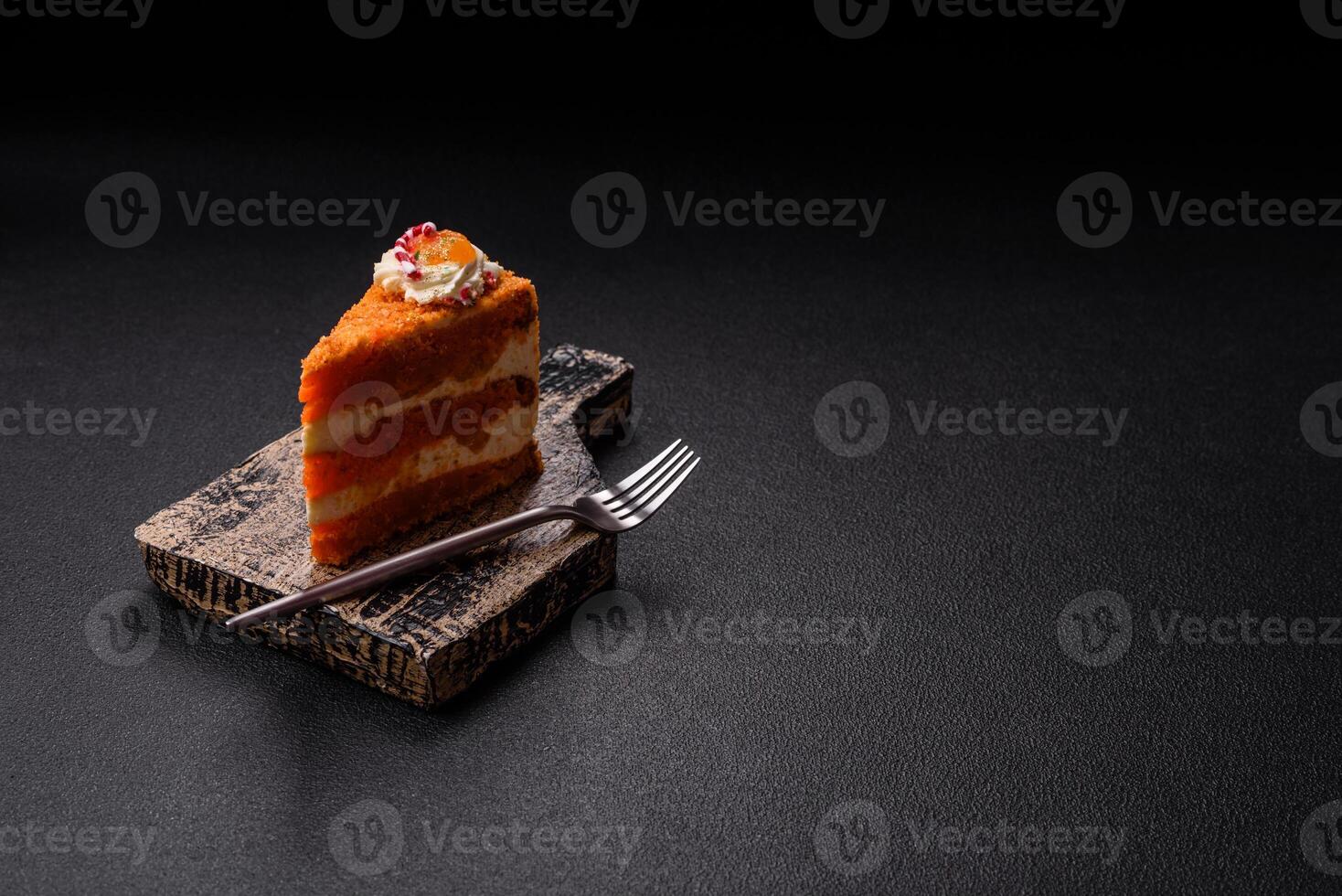 Piece of sweet layer cake with pumpkin or citrus flavor with cream photo