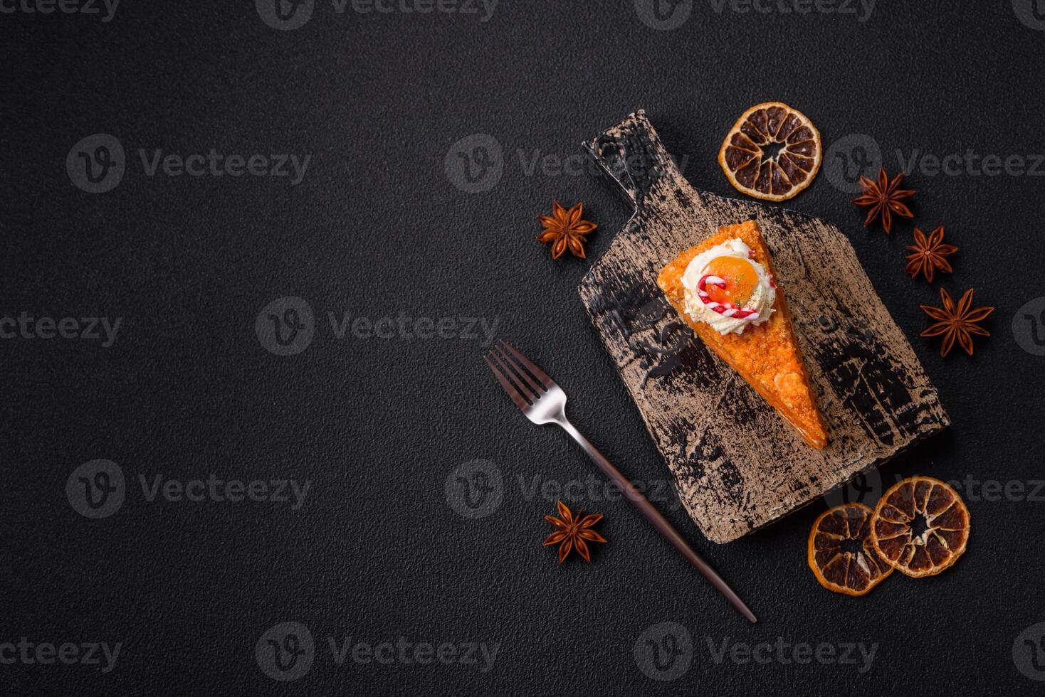 Piece of sweet layer cake with pumpkin or citrus flavor with cream photo