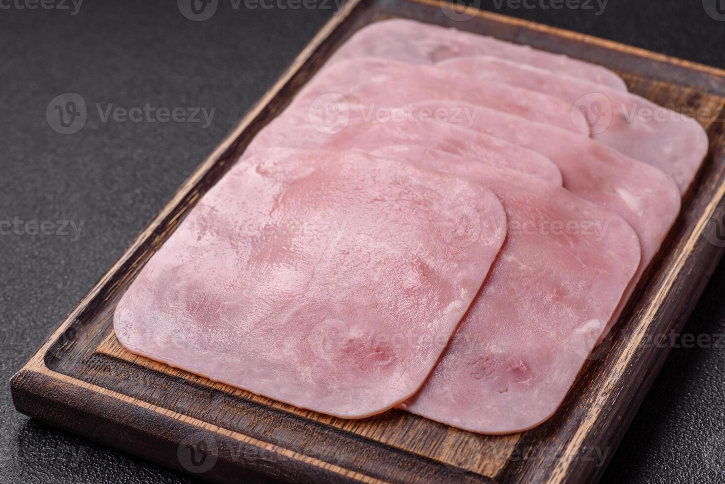 Boiled ham cut into square slices with sorrel and spices photo