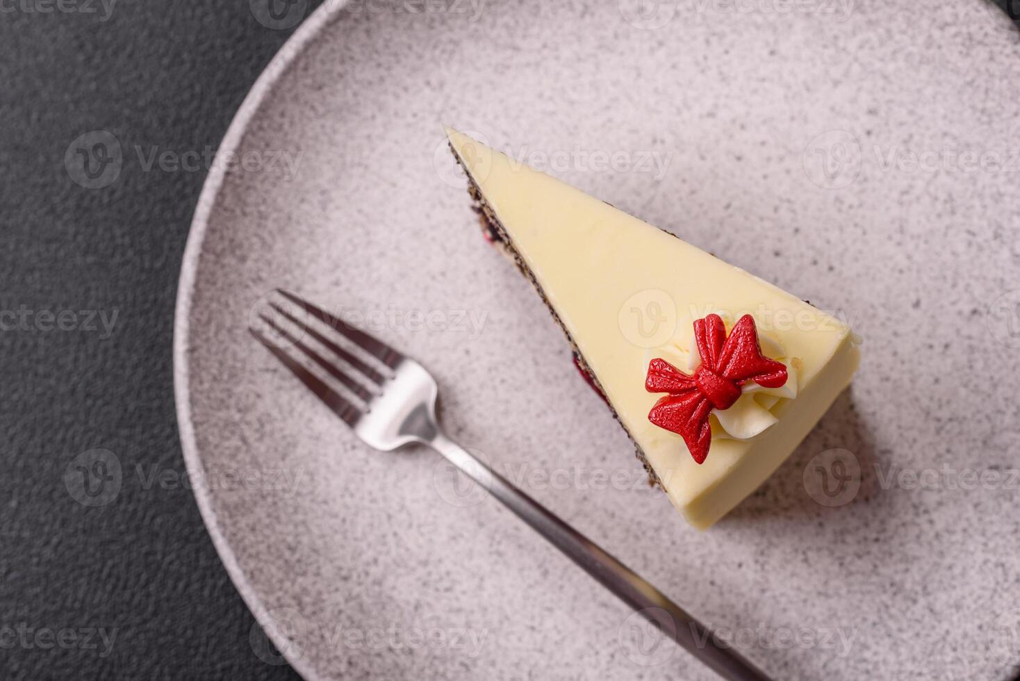 Piece of sweet layered cheesecake with cherries and poppy seeds photo