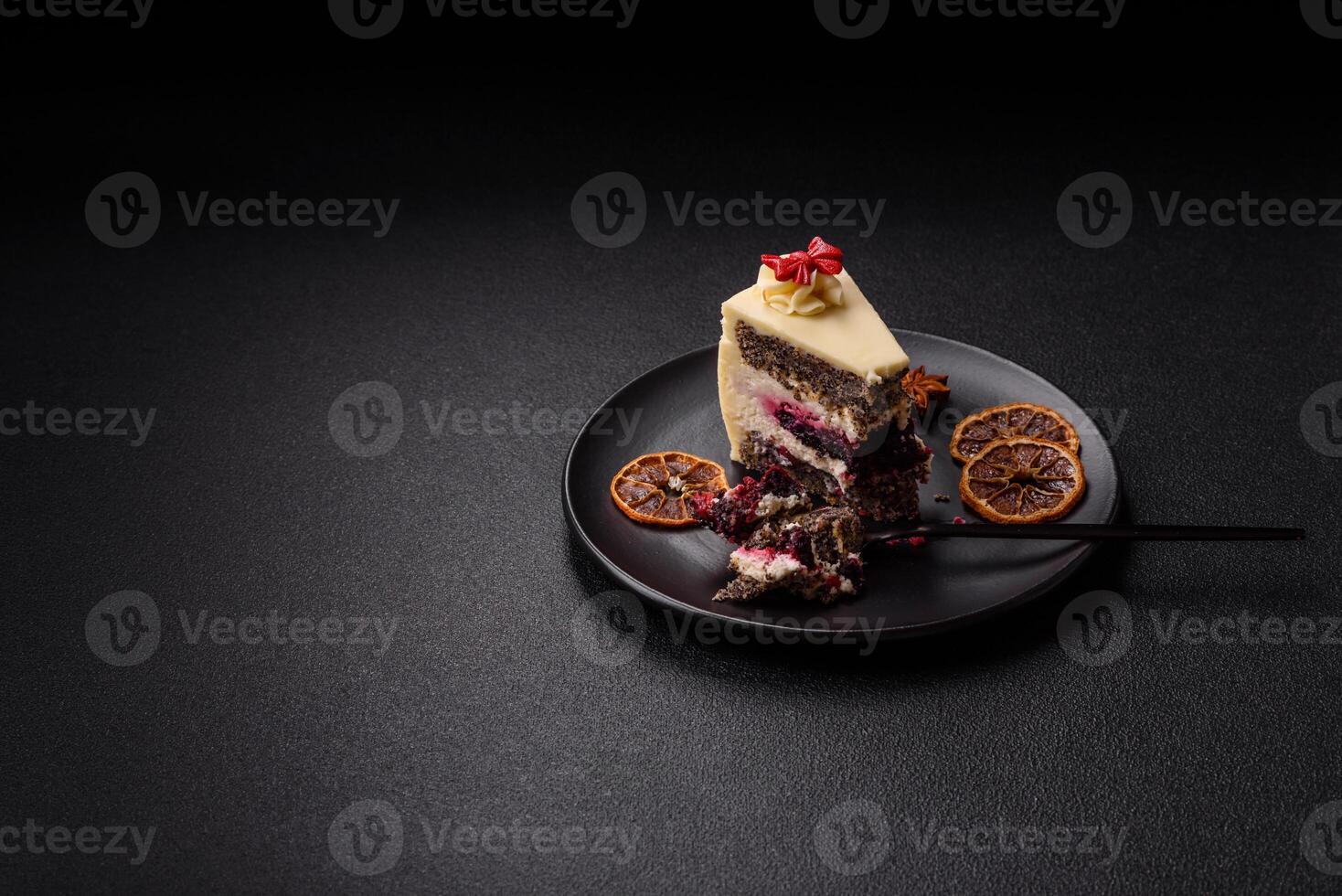 Piece of sweet layered cheesecake with cherries and poppy seeds photo