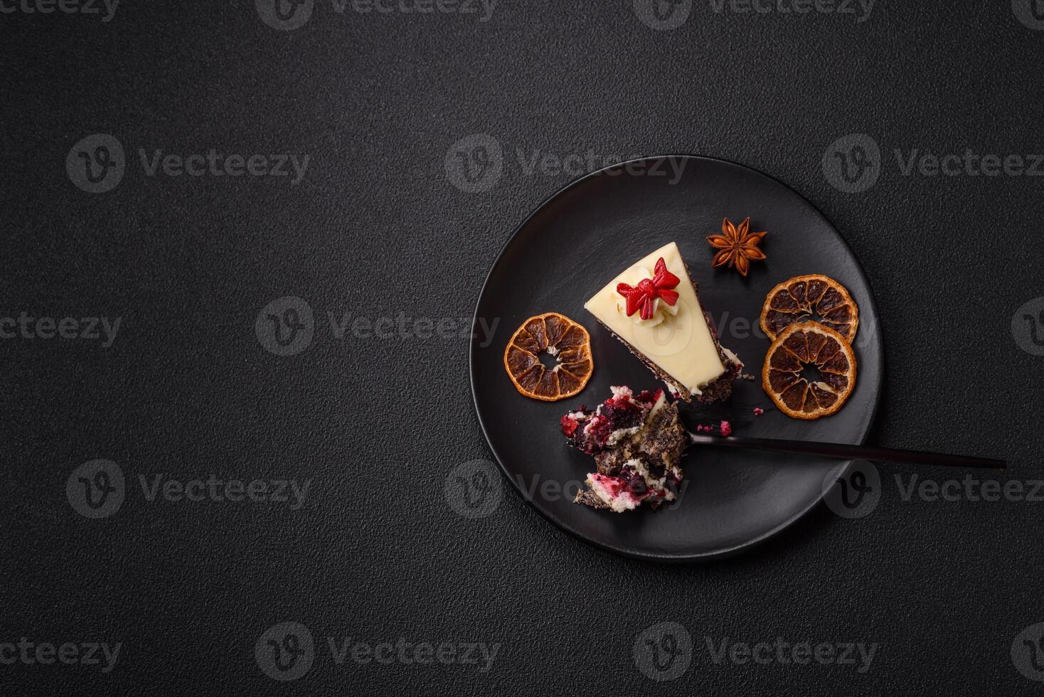 Piece of sweet layered cheesecake with cherries and poppy seeds photo