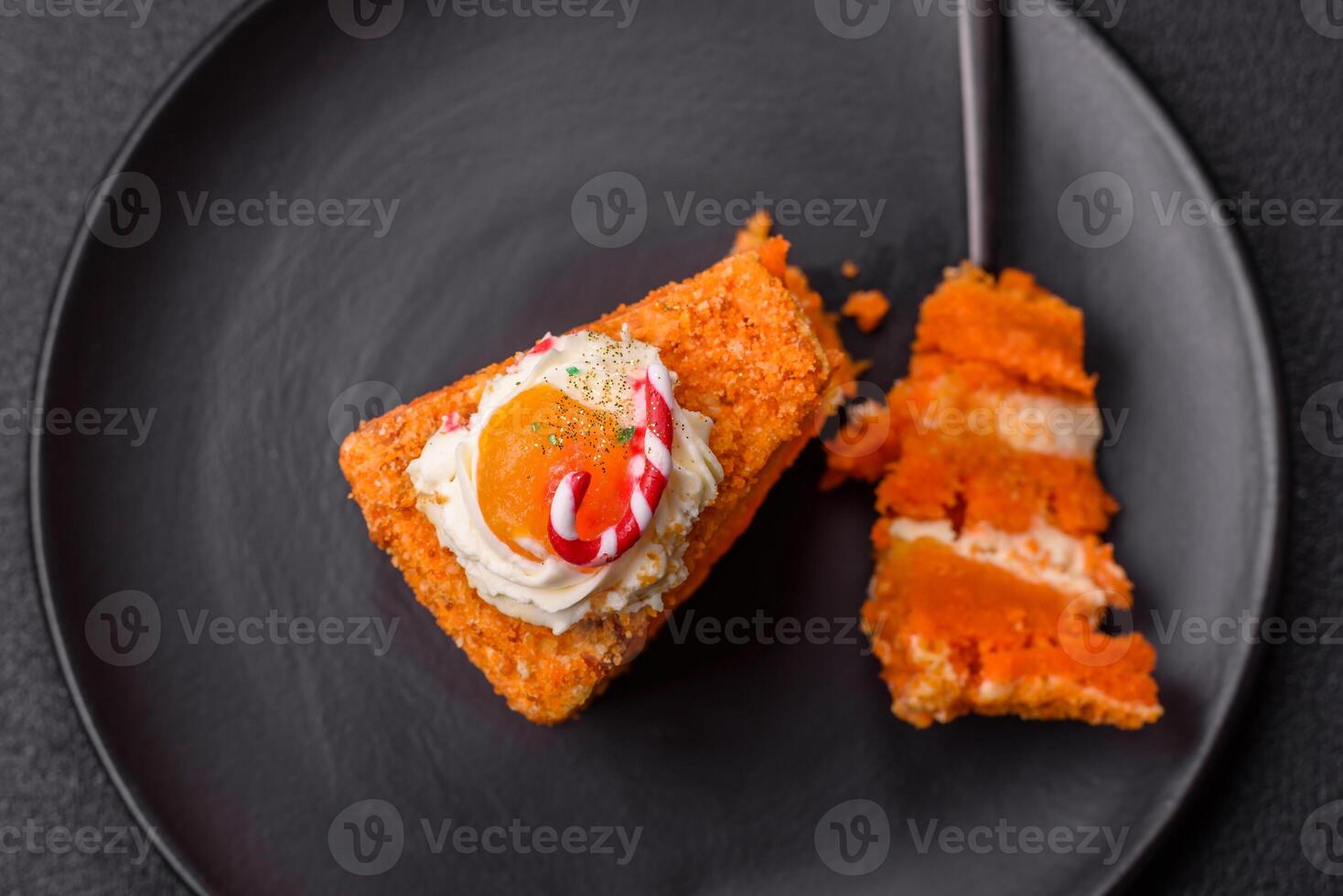Piece of sweet layer cake with pumpkin or citrus flavor with cream photo