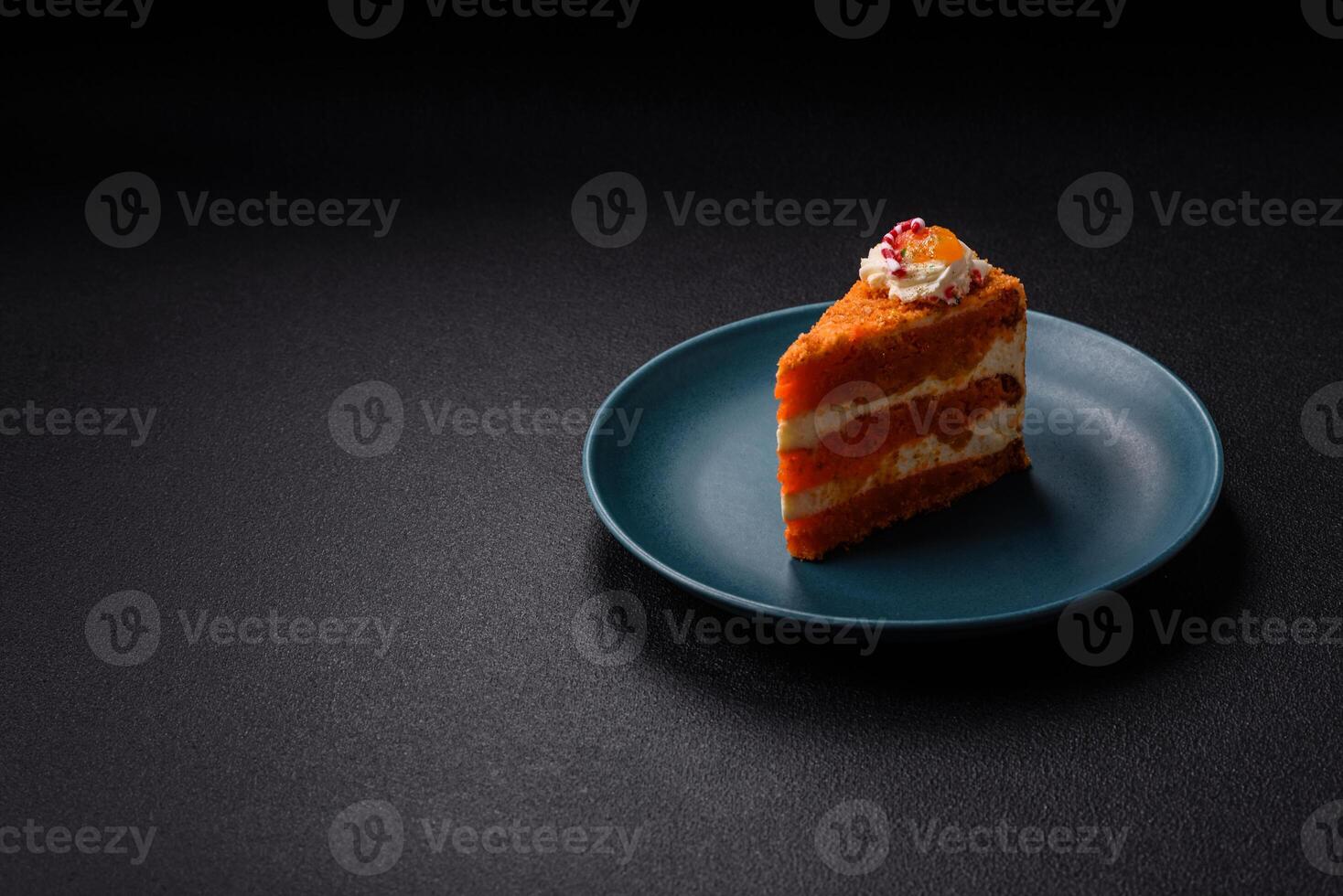 Piece of sweet layer cake with pumpkin or citrus flavor with cream photo