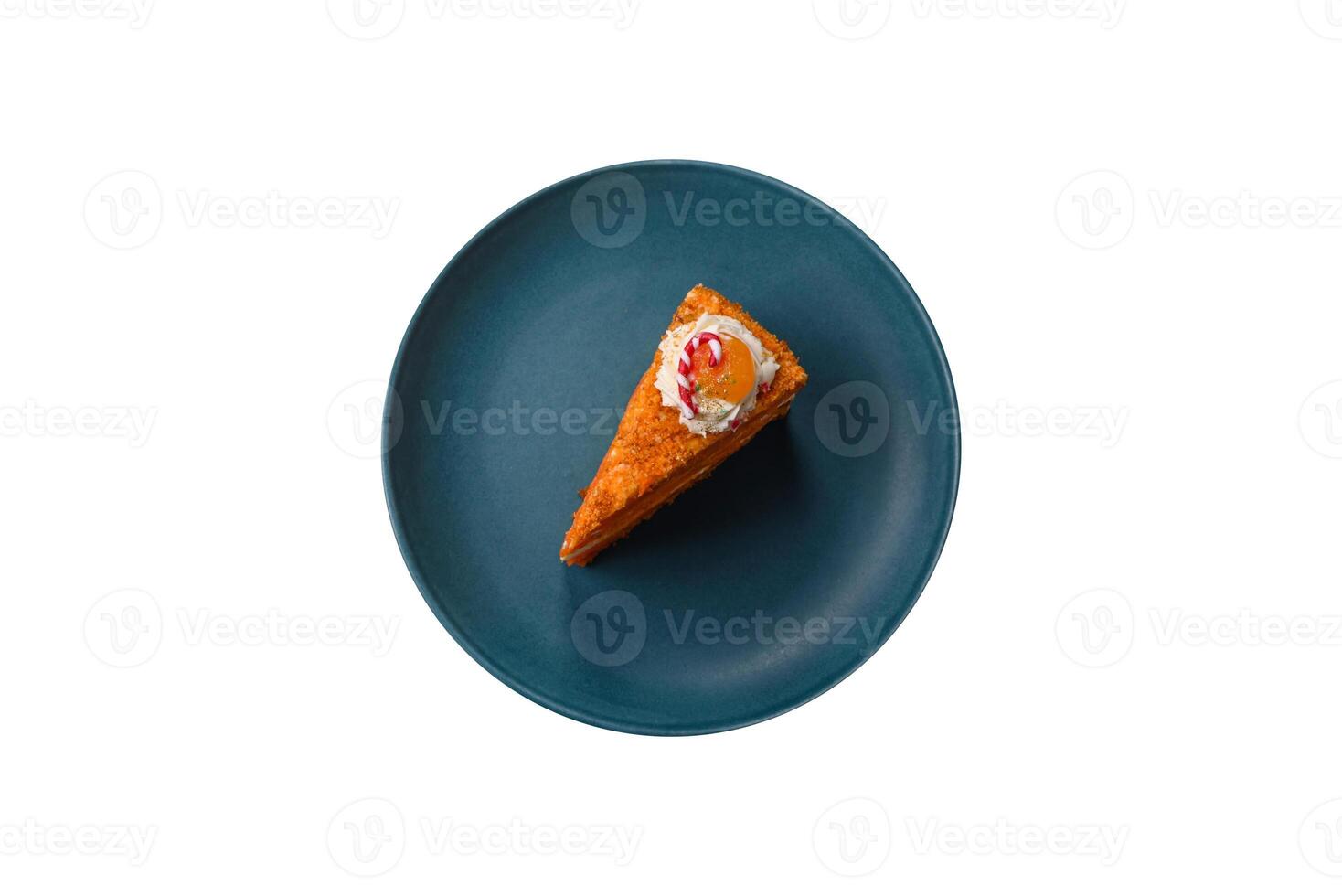 Piece of sweet layer cake with pumpkin or citrus flavor with cream photo