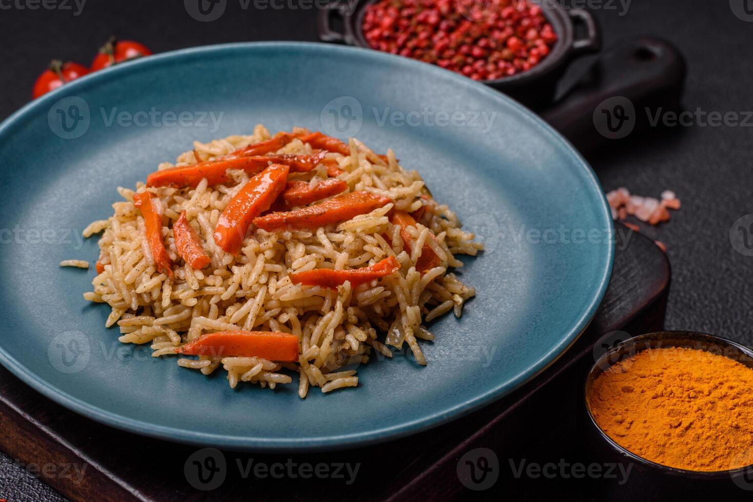Delicious fresh pilaf with rice, carrots, meat, onions, spices and berries photo