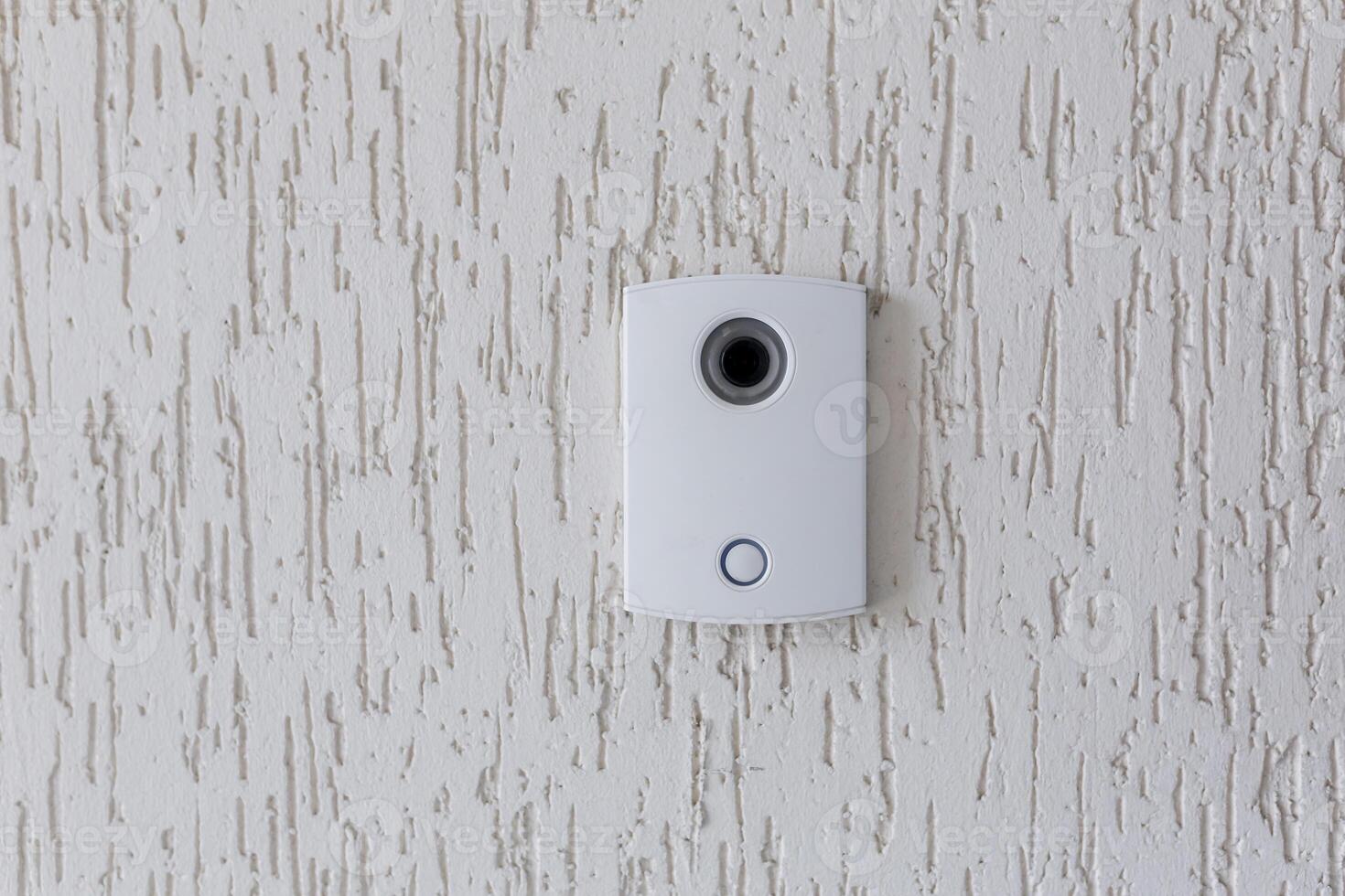 Door lock bell with camera for communication, on white wall of office or home. photo