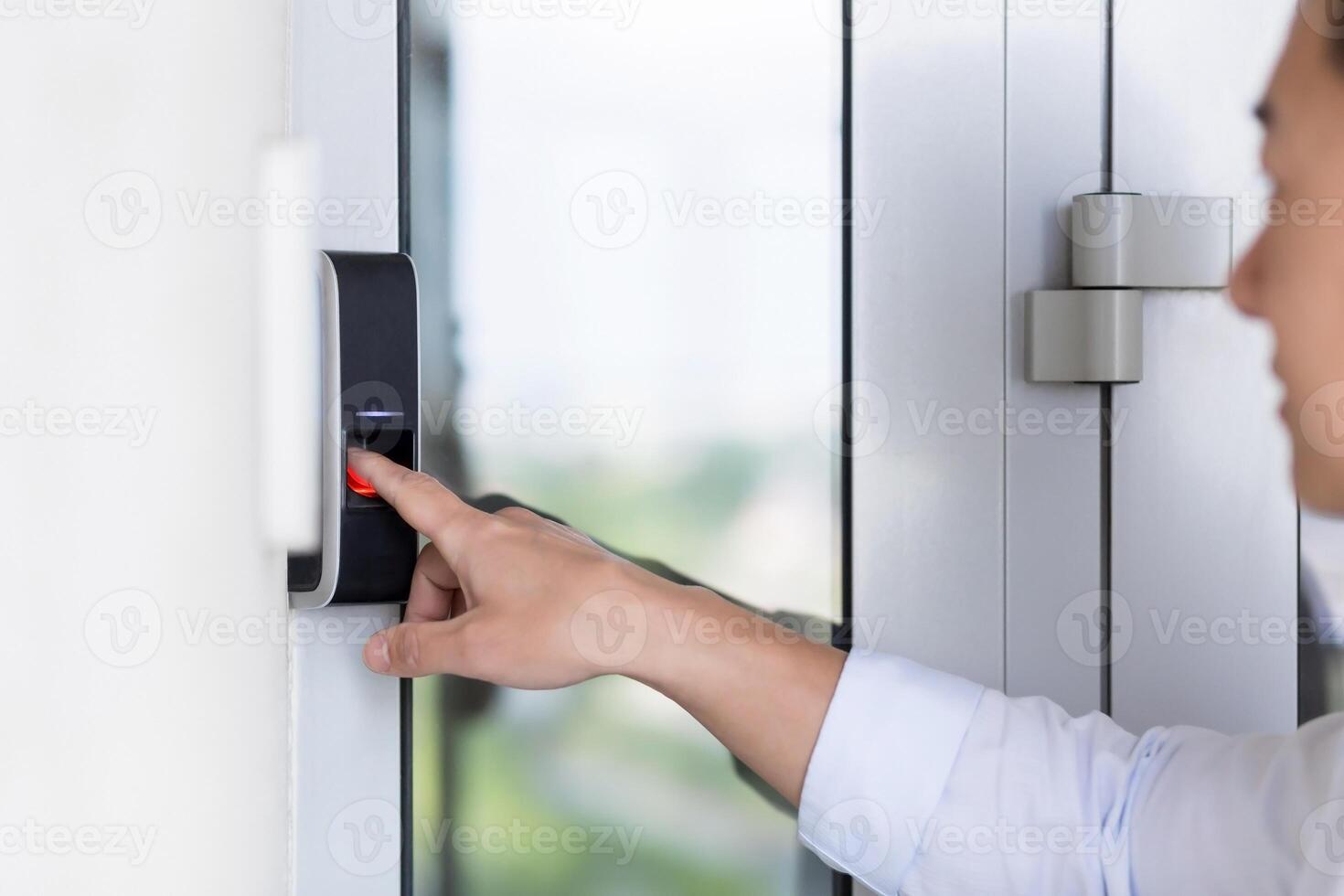 Asian businessman's hand using fingerprint sensor door lock, modern doorbell with camera. photo