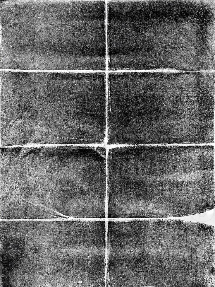 Grunge-style black and white folded paper texture with a distressed, rough appearance, perfect for backgrounds. photo
