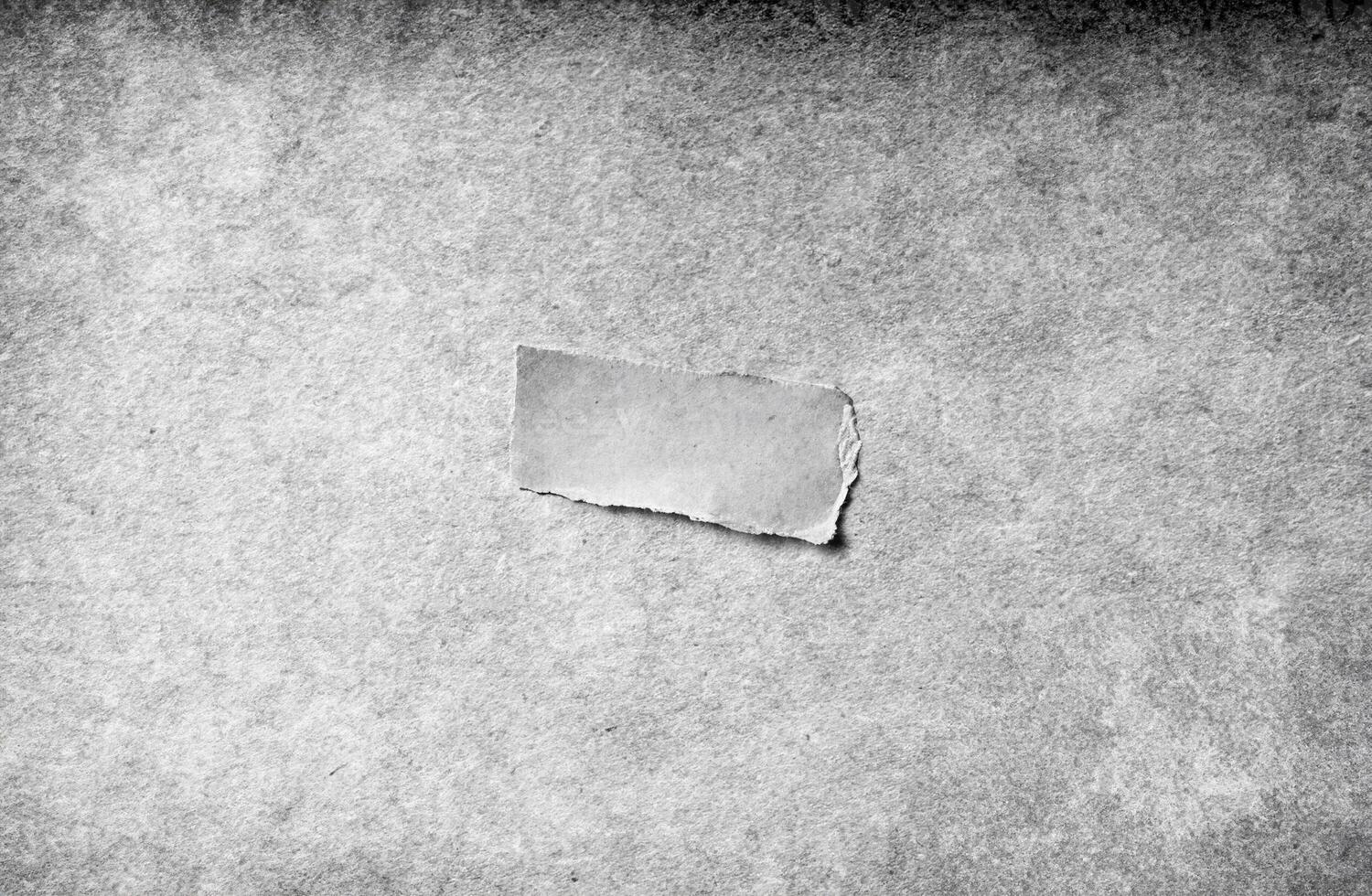 Close-up view of a grungy gray paper texture with rough details, ideal for use as a background or overlay. photo