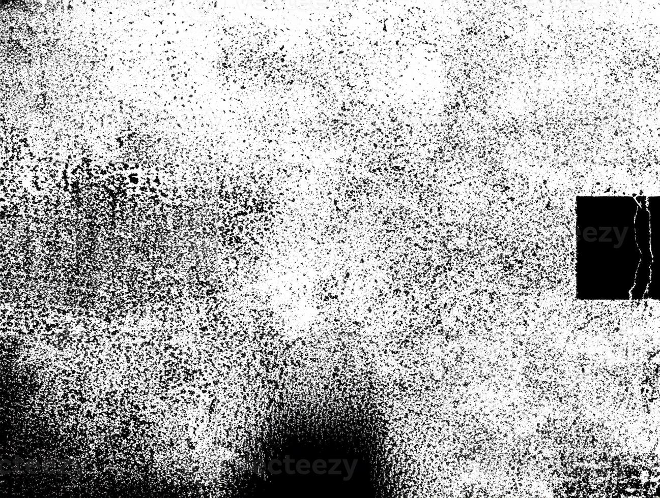 A grunge black and white distressed texture background with a rough, speckled pattern suitable for design overlays. photo