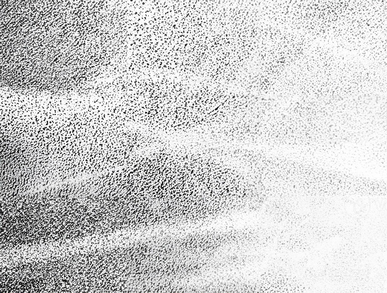 A high-contrast black and white grainy texture featuring soft light streaks, ideal for artistic backgrounds and design overlays. photo