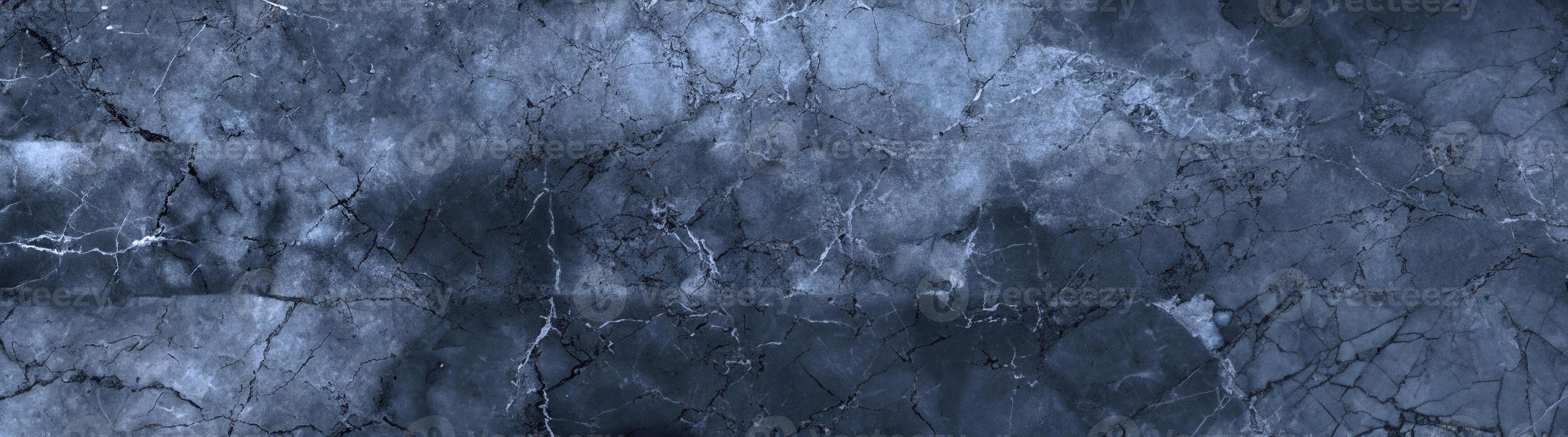Deep blue marble texture featuring organic cracks and natural stone patterns, perfect for backgrounds and design. photo