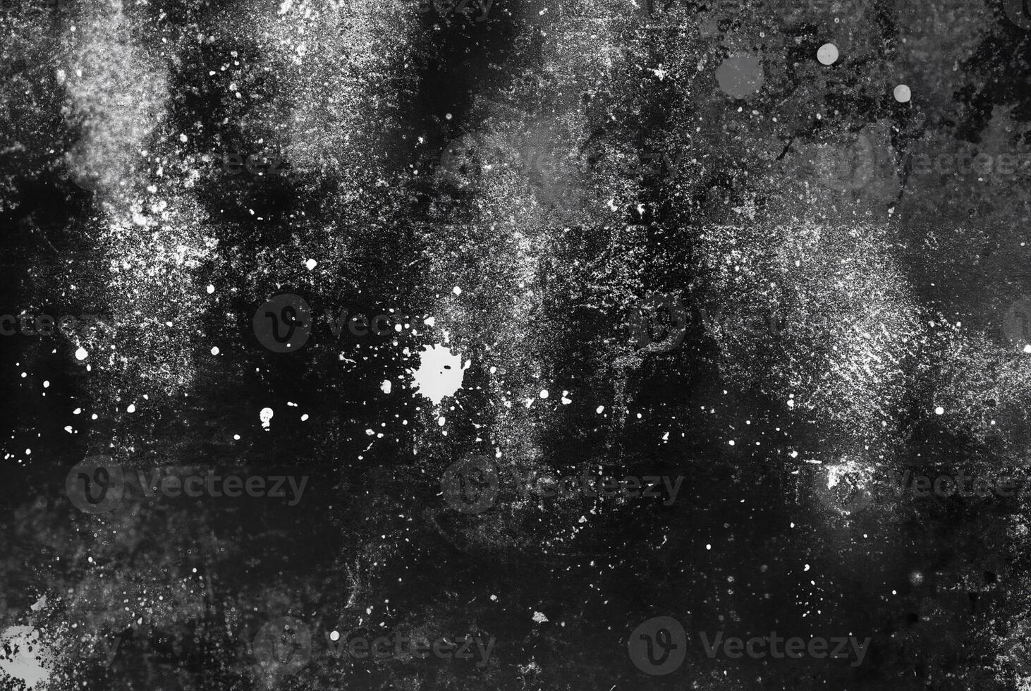 A dark abstract texture with white splatter and streak patterns, evoking a gritty and dramatic artistic effect. photo