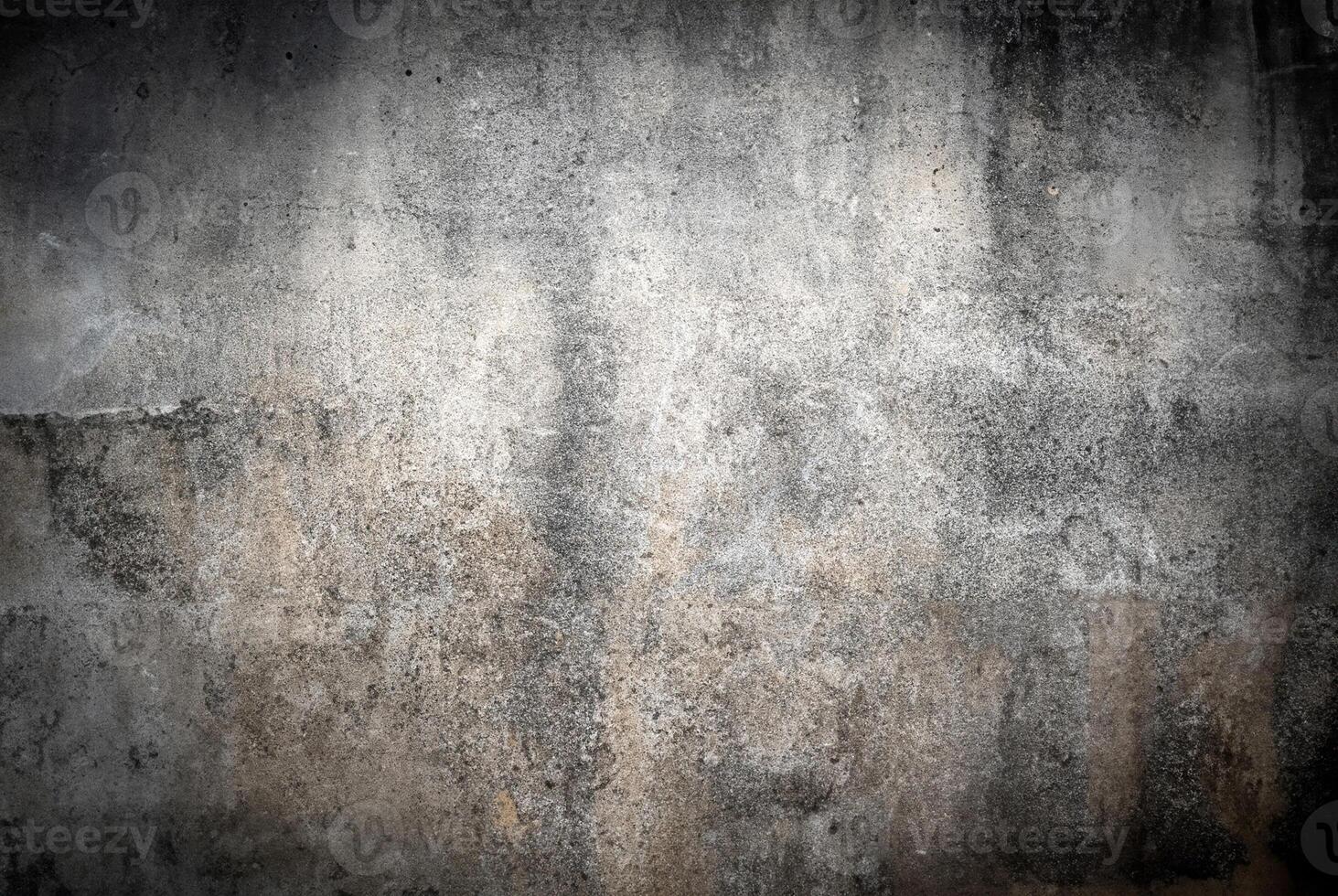 Detailed texture of a weathered concrete wall featuring a grunge-style pattern with subtle shades of gray and beige. photo